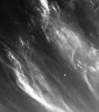 photo of the new moon in a swirl of waves